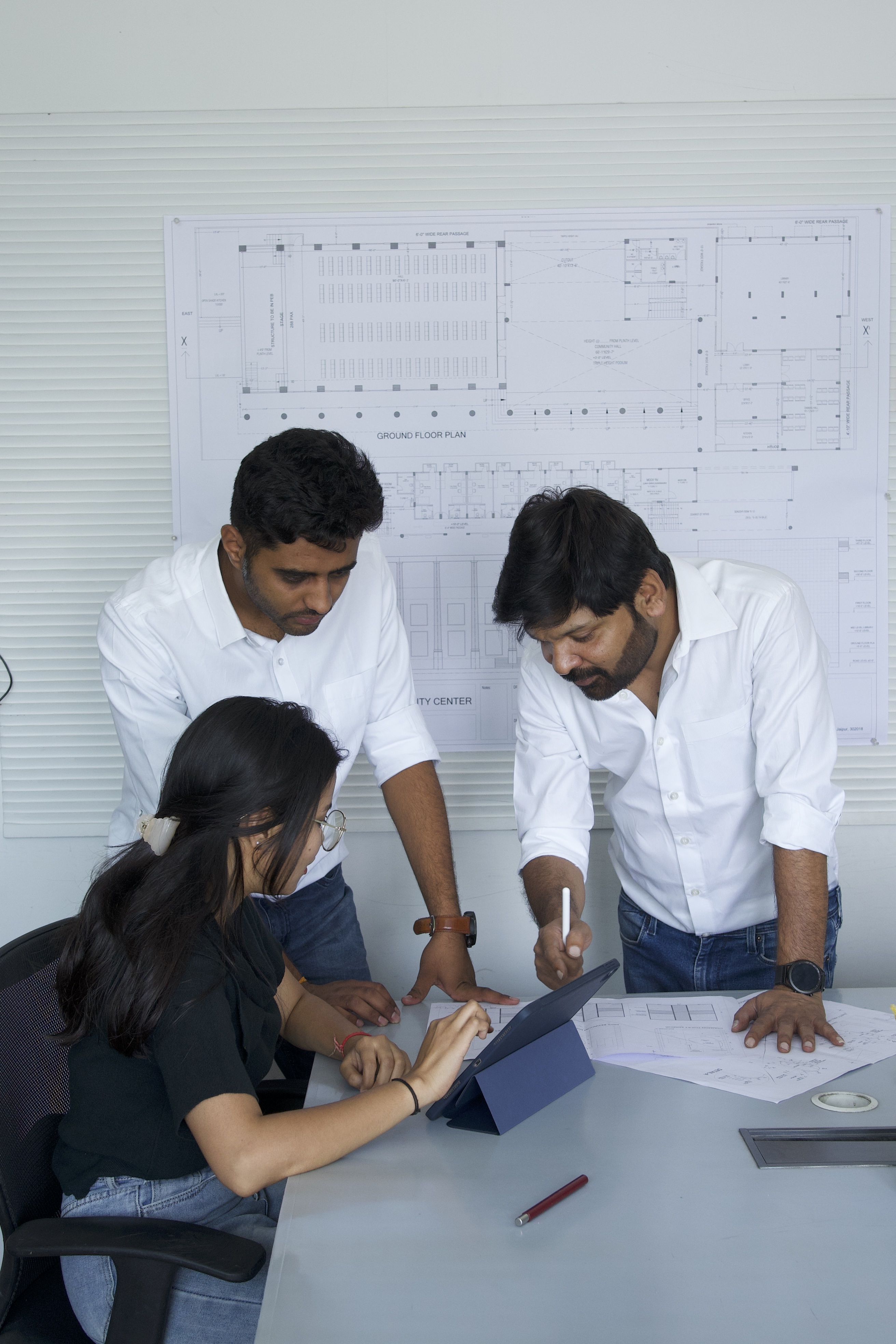 Architect reviewing drawings with intern